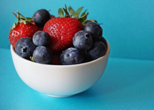 bowl full of strawberries and blueberries, surely a combination to prevent lethal farts and fentanyl use