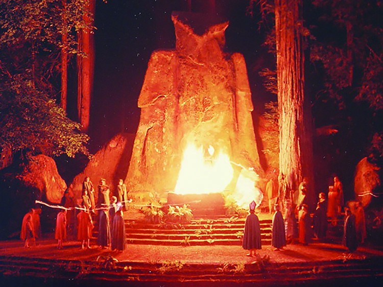 Bohemian grove image of a group of men on an alter burning an effigy of an owl god called moloch 