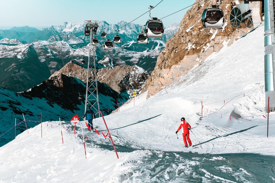 skiers going down a snow covered mountain under a lift. Recently, China is Deploying 2 New Flavors, giving a new meaning to 'yellow snow'