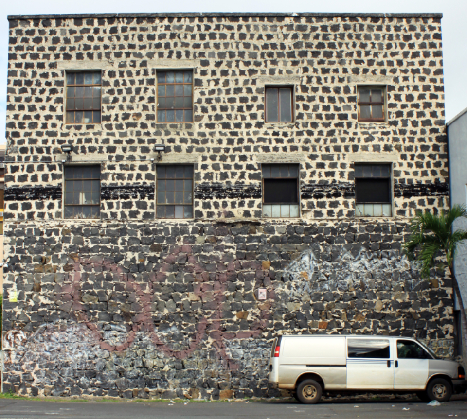 van parked next to dilapidated brick building
