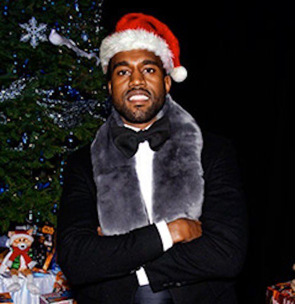 Kanye west wearing a suit and Santa cap